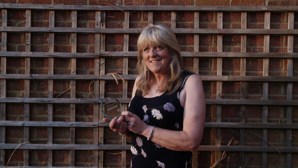 A photograph of Community Trade Union Representative, Janet Sarsfield, holding the Equality & Diversity Award at the Rep Awards.